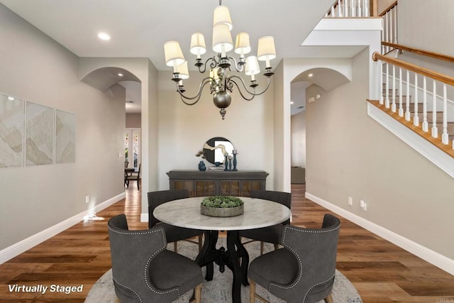 dining room with a notable chandelier and dark wood-type flooring