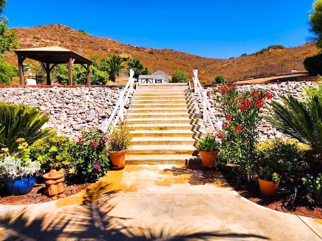 view of patio featuring a gazebo and a mountain view