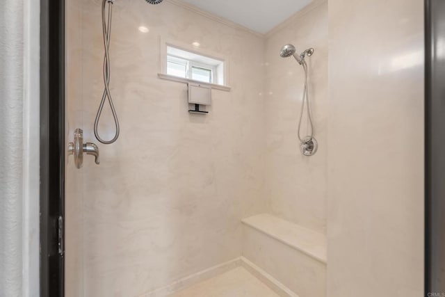 bathroom with crown molding and tiled shower