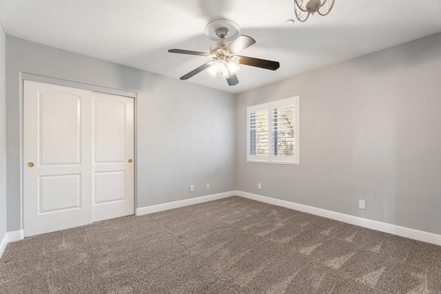 unfurnished bedroom with carpet flooring, ceiling fan, and a closet