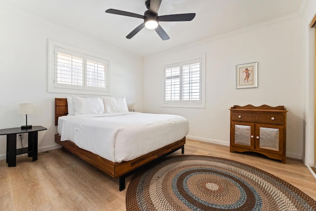 bedroom featuring ceiling fan, ornamental molding, and light hardwood / wood-style flooring