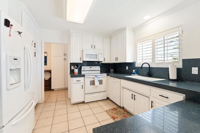 kitchen featuring sink, white cabinetry, decorative backsplash, and white appliances