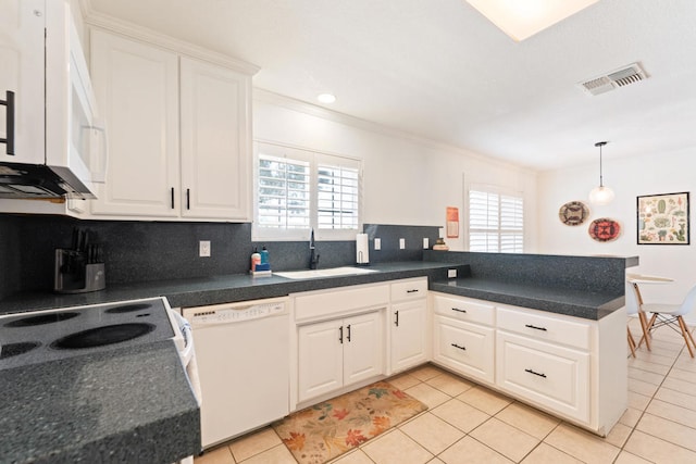 kitchen featuring white appliances, sink, kitchen peninsula, and plenty of natural light