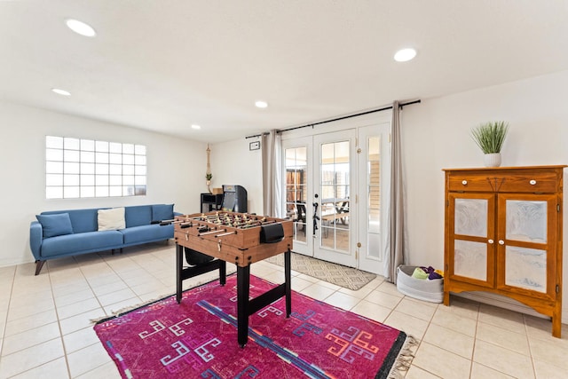 rec room featuring french doors and light tile patterned floors