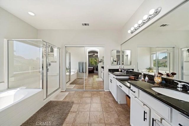 full bathroom with a garden tub, a stall shower, a sink, and visible vents