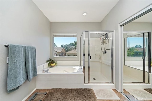 full bath featuring a stall shower and a bath