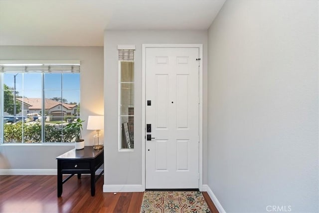 foyer featuring dark wood-style floors and baseboards