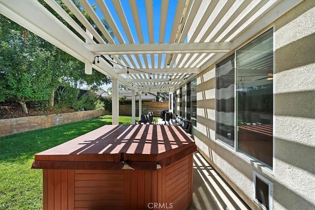 wooden deck featuring fence, a lawn, a hot tub, and a pergola