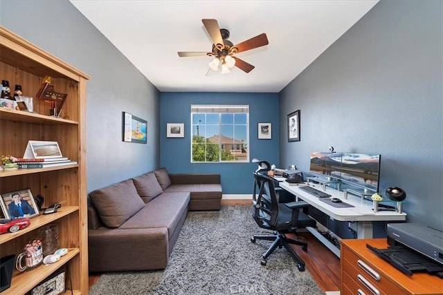 office area featuring ceiling fan, wood finished floors, and baseboards