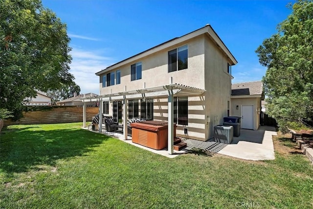 rear view of property with a hot tub, a lawn, fence private yard, a patio area, and a pergola