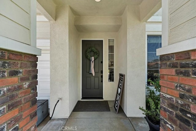 doorway to property with stucco siding