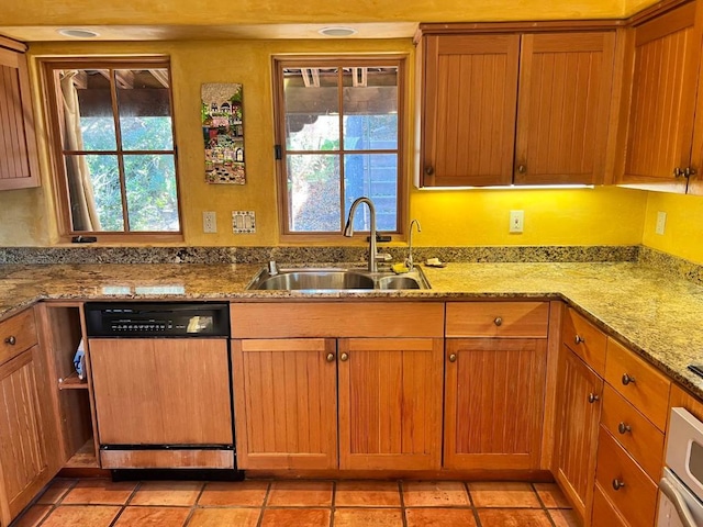 kitchen with dishwashing machine, sink, a wealth of natural light, and light stone countertops