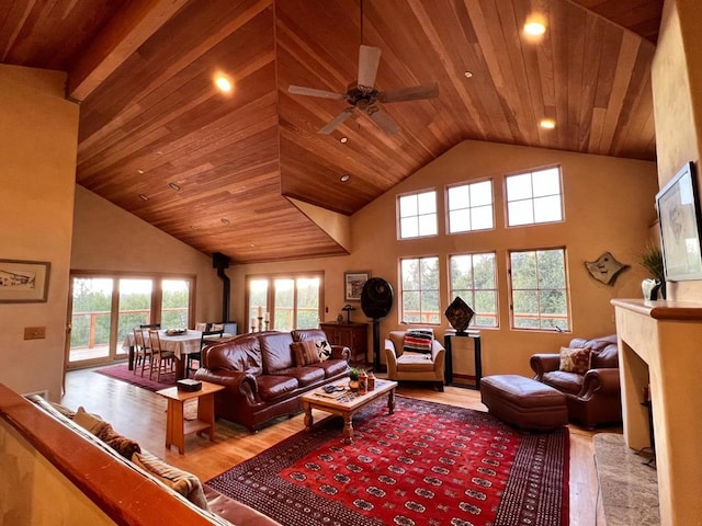 living room featuring a high ceiling, ceiling fan, wooden ceiling, and light wood-type flooring