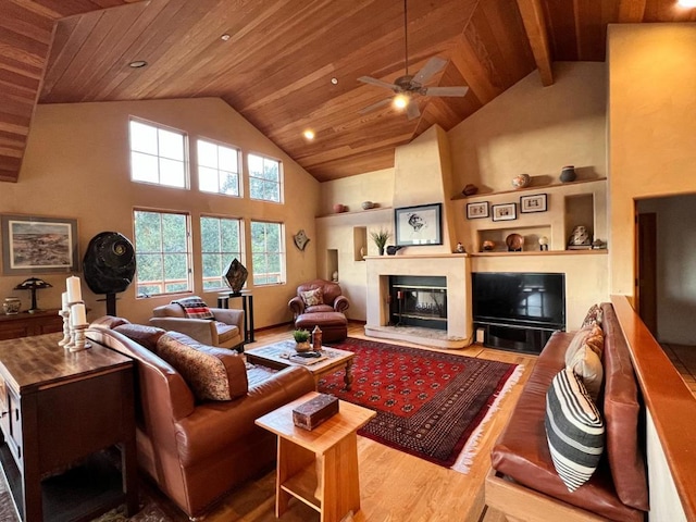 living room featuring wood ceiling, a premium fireplace, ceiling fan, high vaulted ceiling, and wood-type flooring