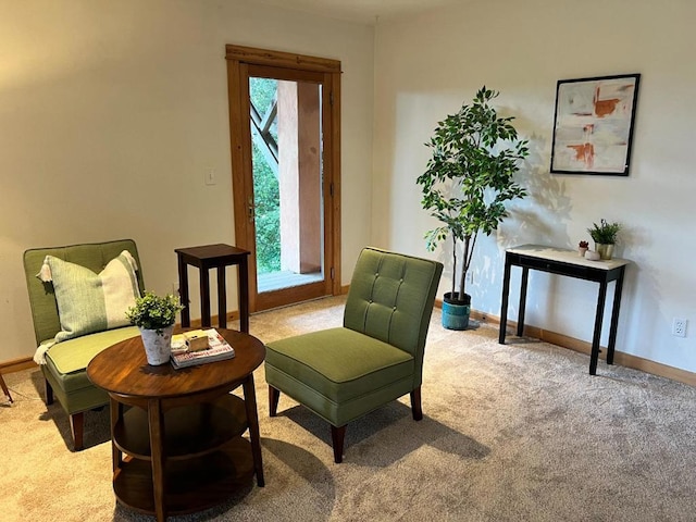 sitting room with plenty of natural light and light carpet