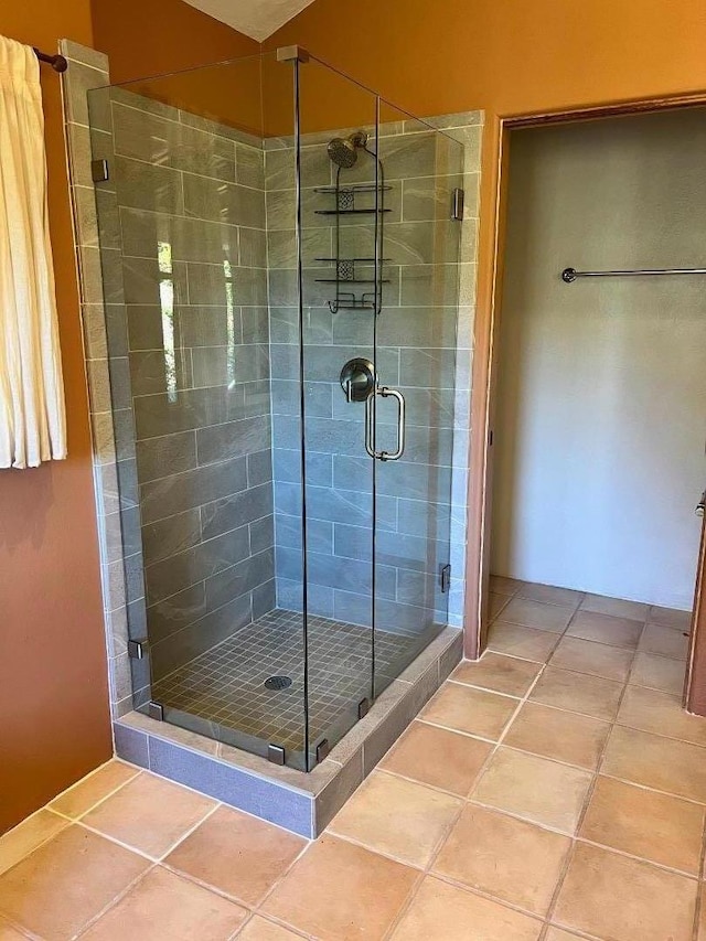 bathroom featuring tile patterned flooring and walk in shower