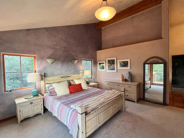 carpeted bedroom featuring lofted ceiling with beams