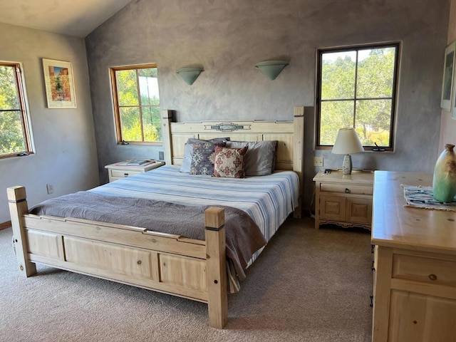 bedroom with light carpet and lofted ceiling