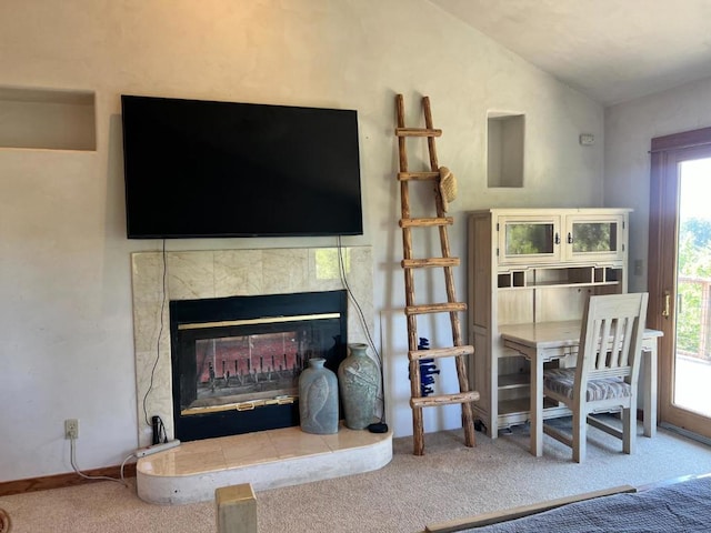 carpeted living room with a fireplace, a wealth of natural light, and vaulted ceiling