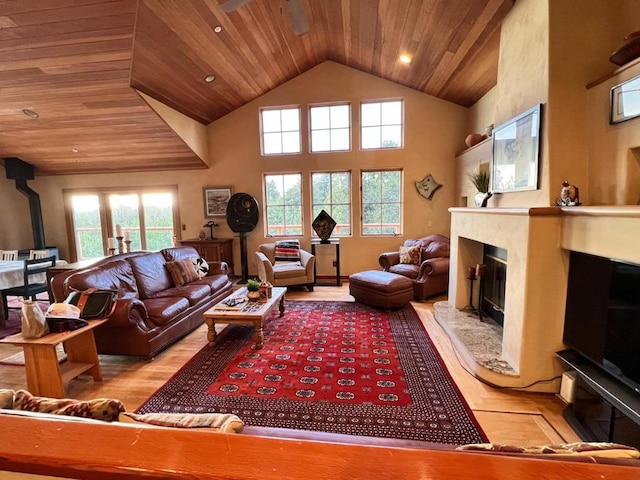 living room with a wealth of natural light, wooden ceiling, and light wood-type flooring