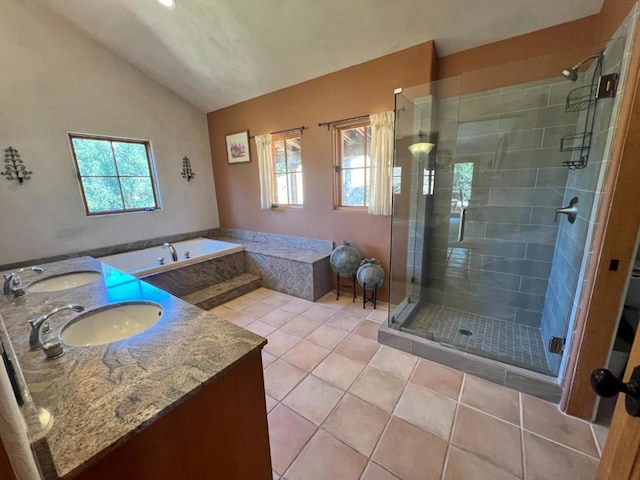 bathroom featuring tile patterned floors, plenty of natural light, independent shower and bath, and vaulted ceiling