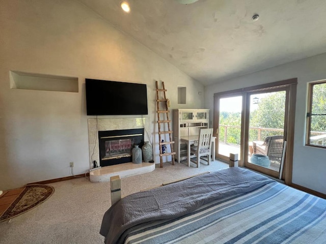 bedroom with a tiled fireplace, carpet floors, access to outside, and vaulted ceiling