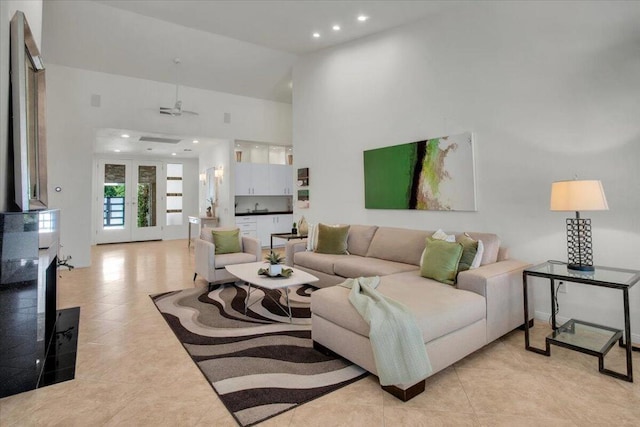 living room featuring light tile patterned floors and ceiling fan