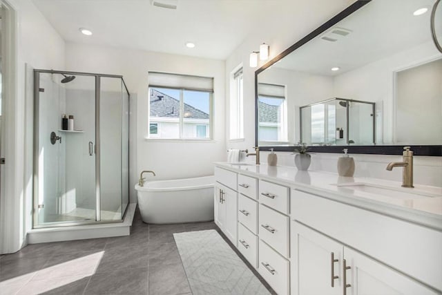 bathroom with tile patterned floors, vanity, and shower with separate bathtub