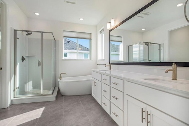 bathroom with tile patterned flooring, vanity, and plus walk in shower