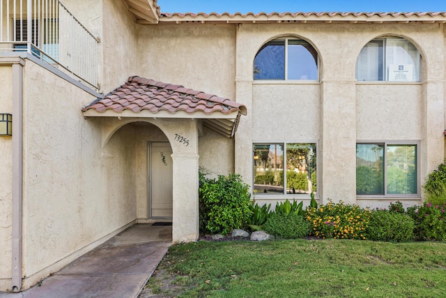 doorway to property featuring a yard