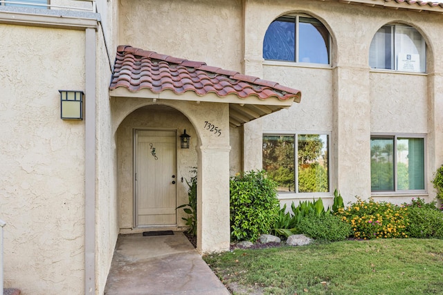 doorway to property featuring a yard