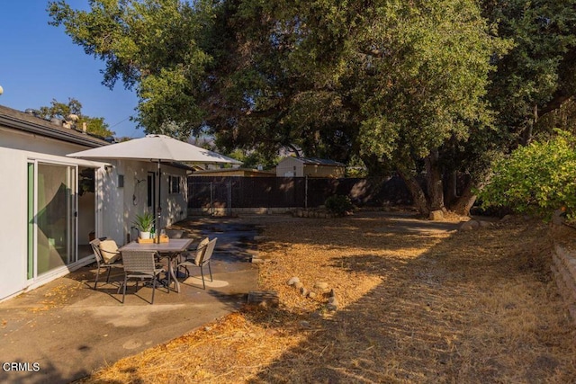 view of yard featuring a patio area and fence