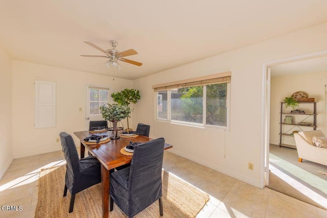 tiled dining space with ceiling fan