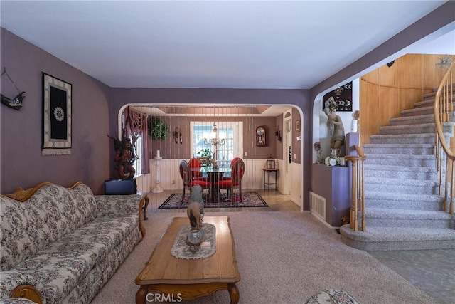 living room featuring a notable chandelier and carpet