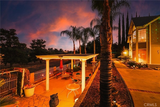 view of patio terrace at dusk