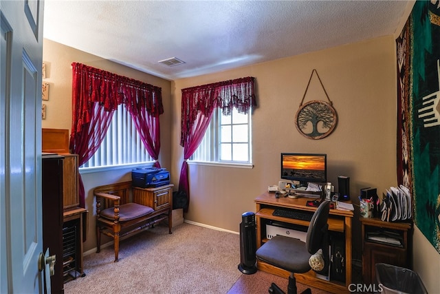 office area with carpet floors and a textured ceiling