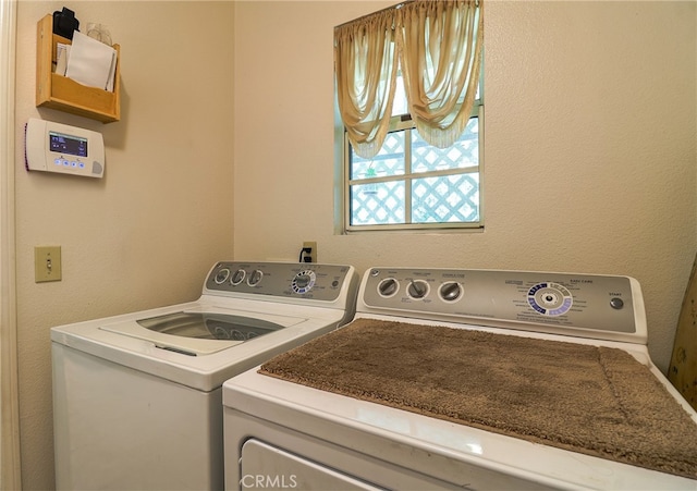 clothes washing area featuring washing machine and clothes dryer