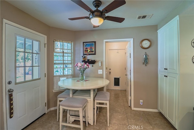 tiled dining area featuring ceiling fan