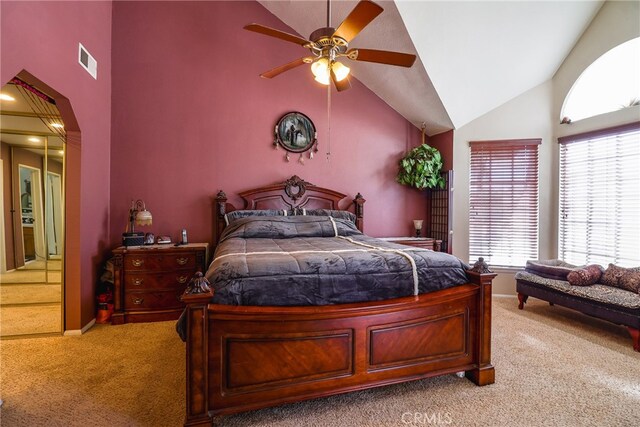 carpeted bedroom featuring ceiling fan and high vaulted ceiling