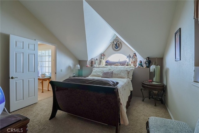 carpeted bedroom featuring lofted ceiling