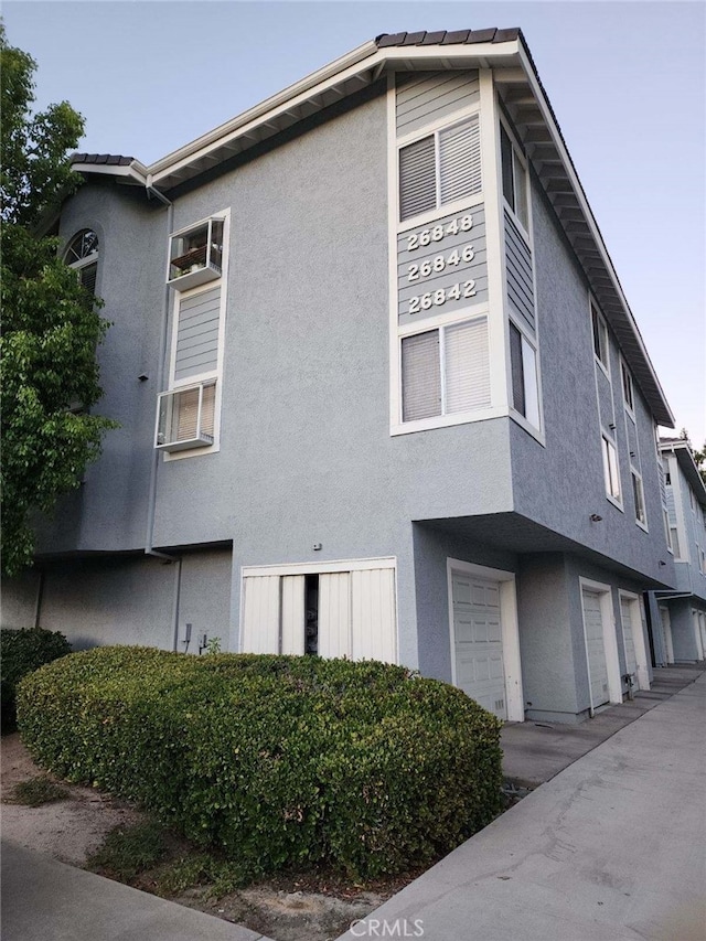 view of home's exterior featuring an attached garage and stucco siding