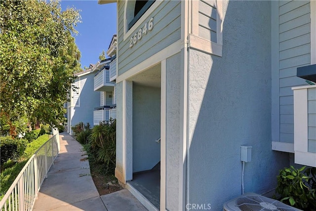 view of property exterior featuring stucco siding and central AC