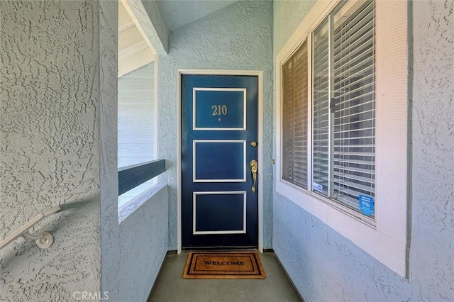 property entrance featuring stucco siding