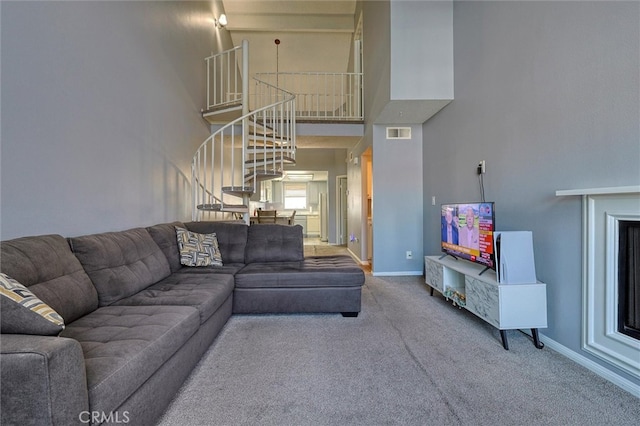 living room featuring carpet floors and a towering ceiling