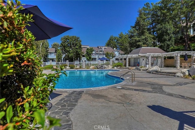 pool featuring a patio and fence