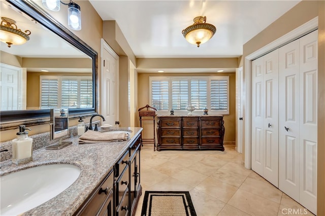 bathroom with vanity, tile patterned flooring, and a wealth of natural light