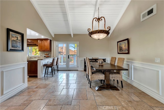 dining space with high vaulted ceiling, beamed ceiling, french doors, and sink