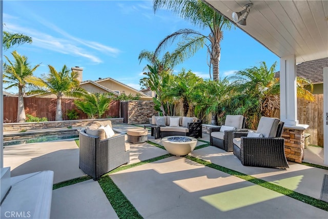 view of patio / terrace with an outdoor living space with a fire pit