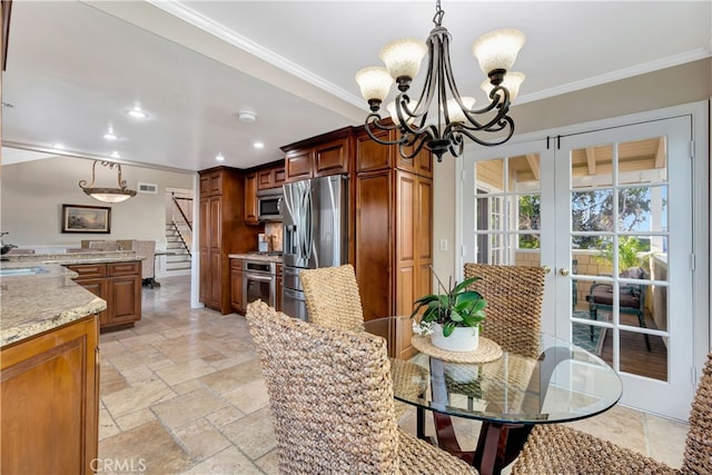 dining room featuring ornamental molding, a notable chandelier, french doors, and sink