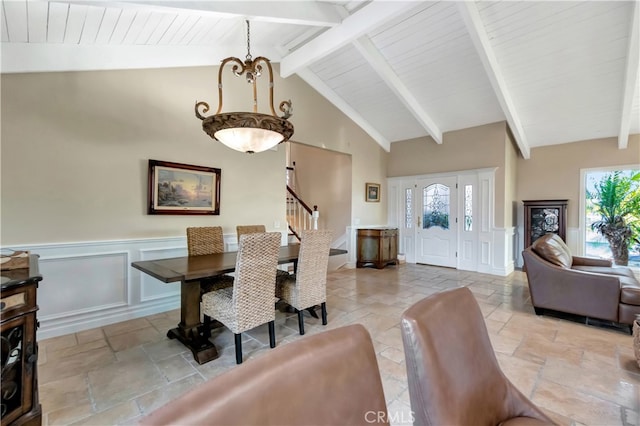 dining space featuring lofted ceiling with beams